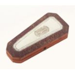 A French etui of tapering form covered in tooled leather, the lid with a white lac panel