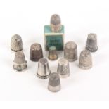 Five foreign white metal thimbles and six 'cased' English thimbles, comprising a small decorative