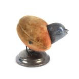 A rare silver pin cushion/thimble case in the form of a chick, the circular silver base below the