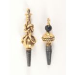 Two 19th Century high carat gold mounted watch keys, comprising an example with glass bead and