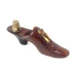 A leather thimble shoe, the heel in black leather the main shoe in brown leather with gilt metal bow