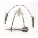 Two German silver knitting needle retainers, comprising an elaborate example in the form of an arrow