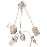 A Victorian silver chatelaine, well fitted, the hinged clip to a mask and 'C' scroll mount with