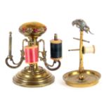 Two brass reel stands, comprising a French example, the circular dished base to a stem with six reel