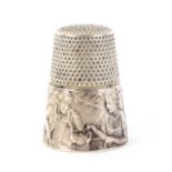 An early 20th Century French thimble, the frieze depicting an elderly man and woman seated at a