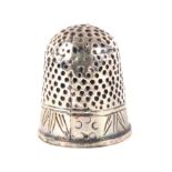 A small early 18th Century silver thimble, the frieze engraved with pointed leaf motifs and dots.