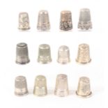 Twelve continental white metal thimbles, some with decorative friezes, some stamped, some with