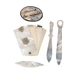 A mixed lot of mother of pearl items, comprising an oval pin cushion inscribed 'A Present +++