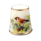 A Royal Worcester porcelain puce mark thimble painted with a bird, on a leafy branch between gilt