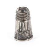 An early 19th Century English silver thimble, the frieze depicting Lichfield Cathedral, small loss