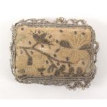 An 18th Century embroidered pin cushion, of rectangular form each side worked with flowering