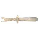 A fine Palais Royal letter knife in mother of pearl, the handle carved as a dog at rest with