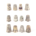 Twelve continental white metal thimbles, some with decorative friezes, some stamped, some with