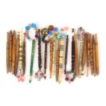 A collection of twenty two antique lace bobbins, comprising thirteen Honiton, most with aqua