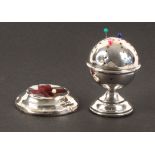 Two silver pin cushions, comprising a ball form example on circular pedestal base, Birmingham