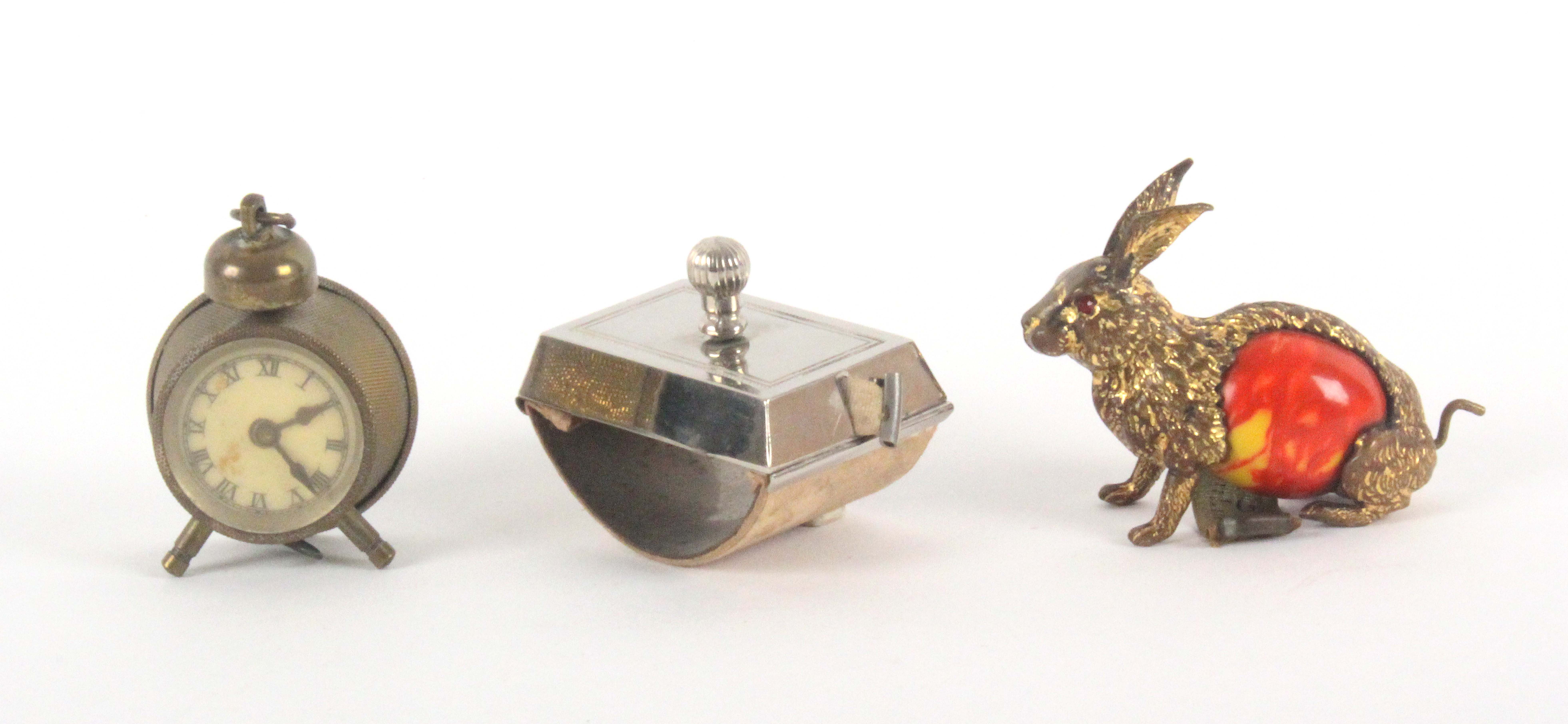 Three metal novelty tape measures, comprising a seated hare with celluloid body, the complete