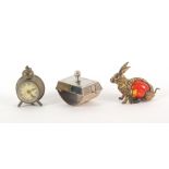 Three metal novelty tape measures, comprising a seated hare with celluloid body, the complete