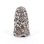 A good example of an Indian silver Kutch thimble, of tall form boldly decorated with flower heads