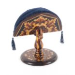 A rosewood Tunbridge ware ring stand and pin cushion, the fan form pin cushion in geometric mosaic