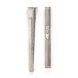 Two 19th Century Dutch silver bodkin or needle cases, comprising a reeded cylinder form example with