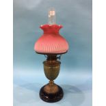 An oil lamp, with pink shade