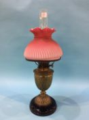 An oil lamp, with pink shade