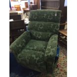 A green floral rise and recliner armchair