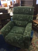 A green floral rise and recliner armchair