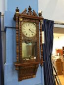 A walnut wall clock, with eight day movement