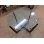 A teak and glass circular top coffee table