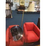 Pair of red swivel chairs and a lamp