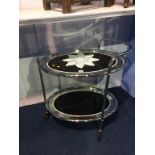 A retro chrome two tier mirrored glass oval tea trolley