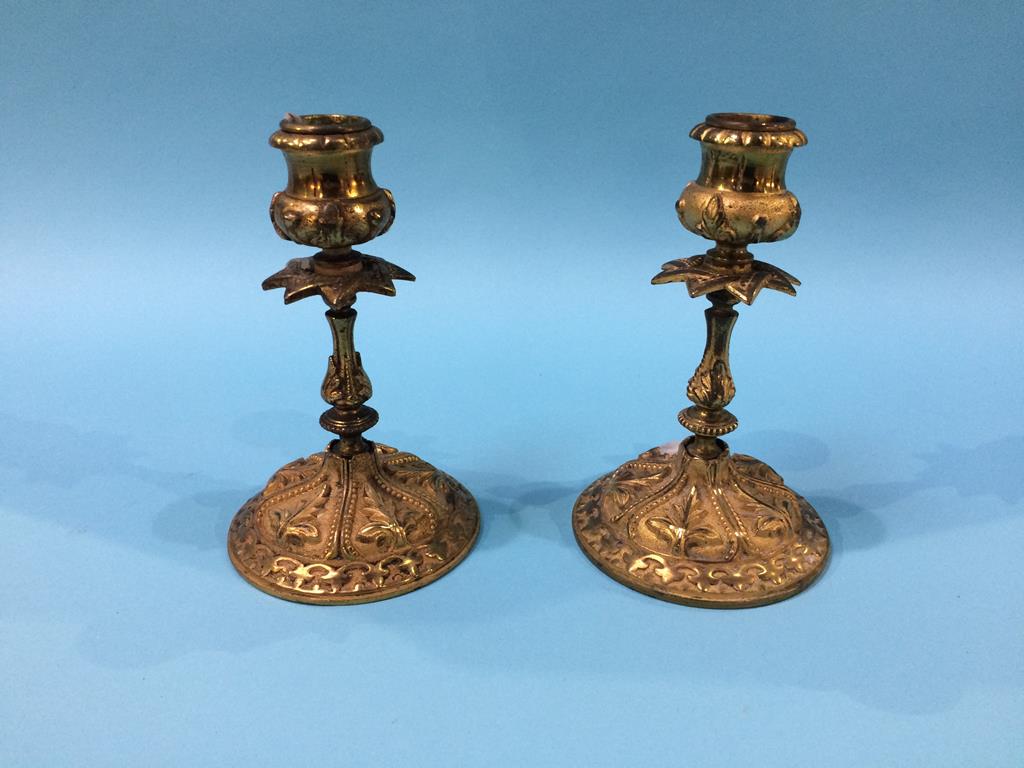 A small pair of ornate Ormolu candlesticks stamped, 16cm height