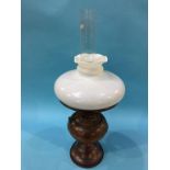 An oil lamp, with white shade