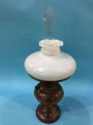 An oil lamp, with white shade