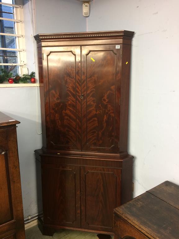 A reproduction mahogany corner cabinet