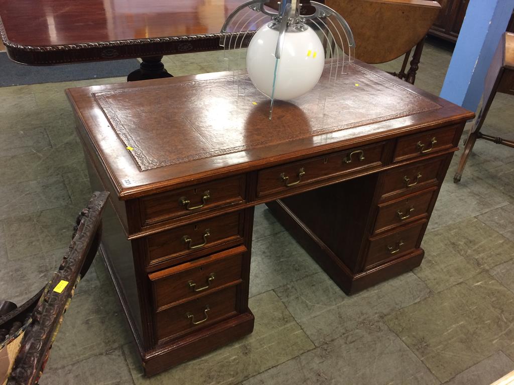 A reproduction mahogany pedestal desk