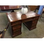 A reproduction mahogany pedestal desk