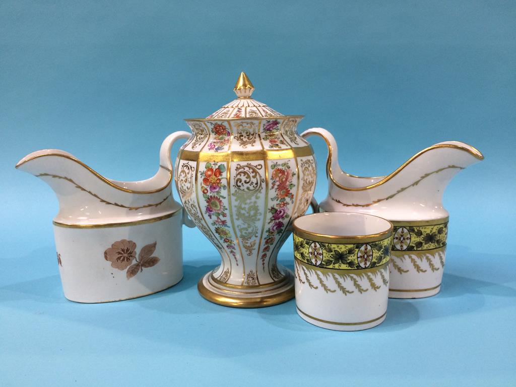 An early 19th century porcelain cream jug and matching coffee can, another porcelain jug and a