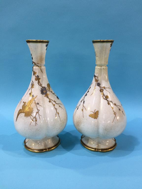 A pair of Royal Worcester vases, numbered 582, decorated with gilded butterflies and cranes, green