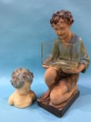 An Art Deco plaster figure of a boy holding a fish bowl and a smaller bust, 52cm height