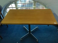 A teak McIntosh and Co. Ltd swivel top fold over table, supported on a chrome base