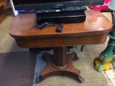 A Victorian mahogany fold over tea table