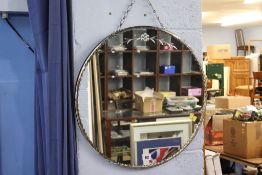 A circular frameless mirror