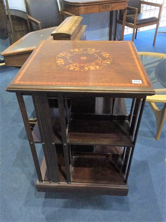 An Edwardian marquetry inlaid revolving bookcase