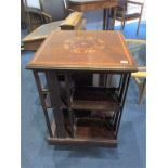An Edwardian marquetry inlaid revolving bookcase