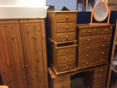 Three pine chest of drawers, a dressing table and wardrobe