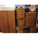 Three pine chest of drawers, a dressing table and wardrobe