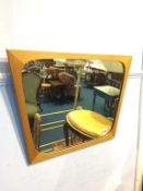 A teak framed mirror