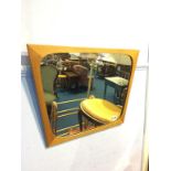 A teak framed mirror